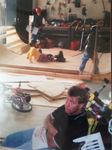 Dad taking a break from building the skateboard half-pipe.